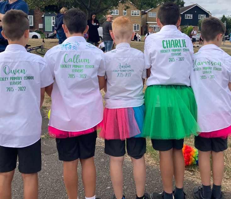 Group of children wearing personalised Hockley Primary School leavers shirts, standing together.
