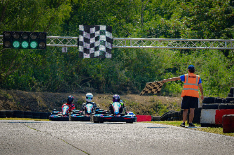 A dynamic scene of go-kart drivers competing on the track at Brentwood Karting, highlighting the thrill and excitement of karting for all ages and skill levels.