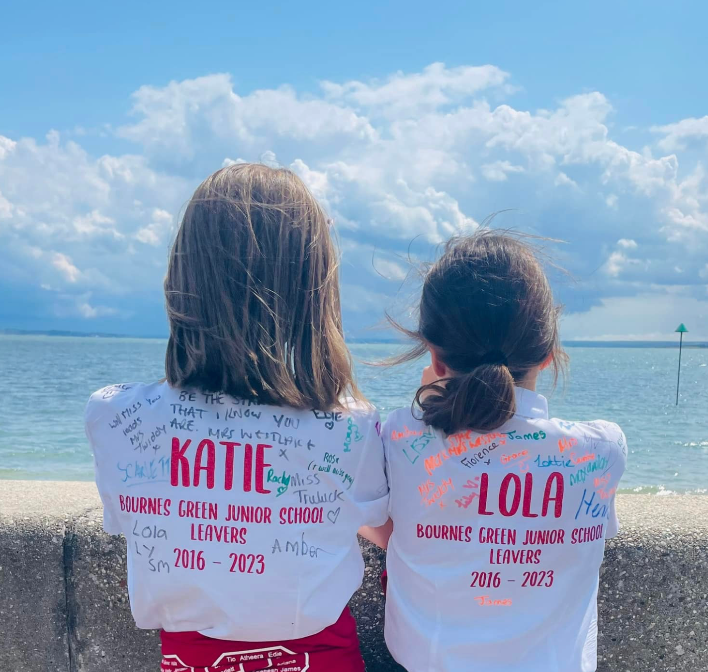 Children wearing signed personalised Bournes Green Junior School leavers shirt with their name, school and on the years spent at the school on the back.
