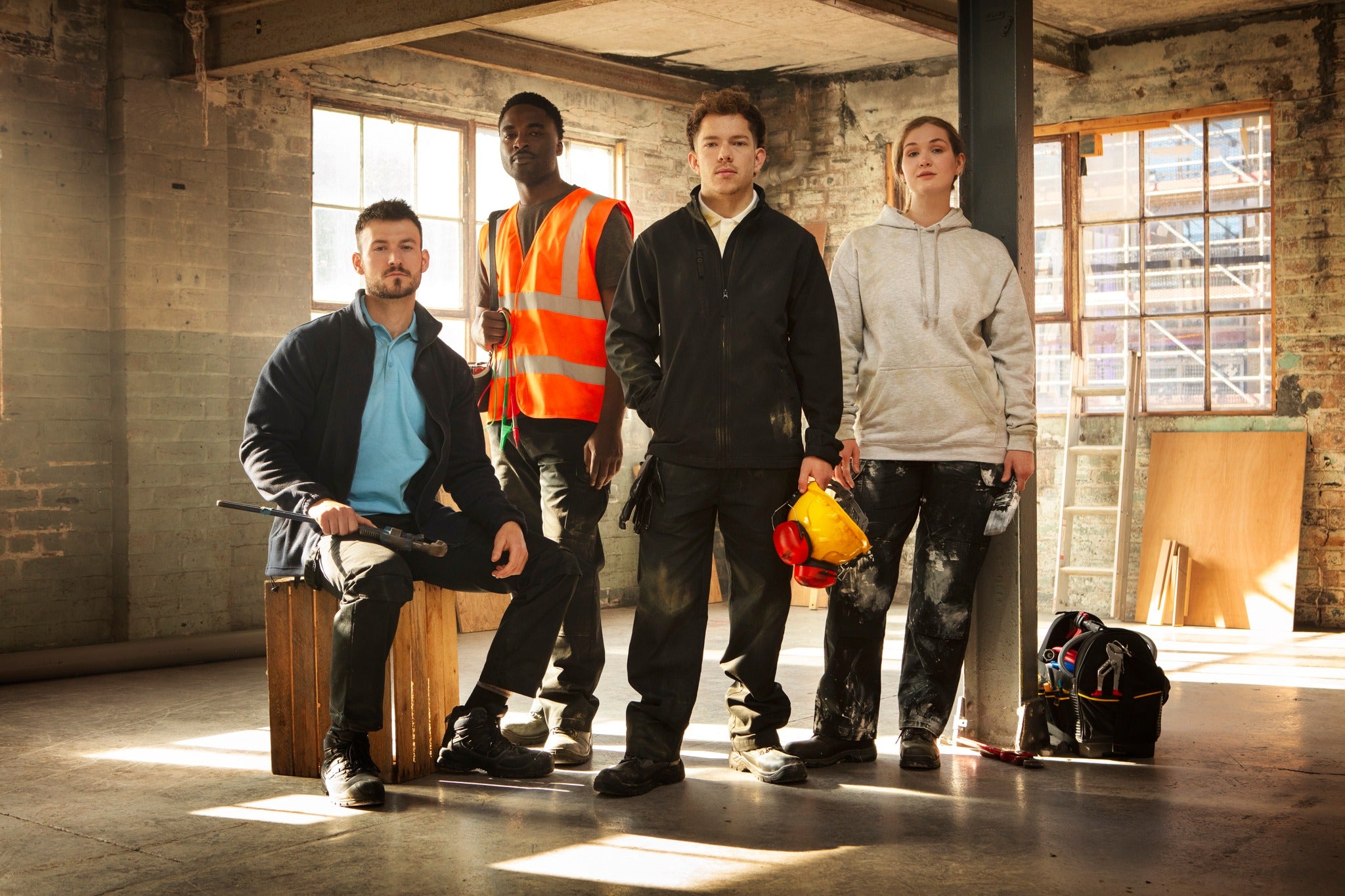 Cover image for the RTX workwear brand featuring a group of workers in an industrial setting, showcasing RTX clothing such as polo shirts, hoodies, high-visibility vests, and jackets, designed for durability and functionality.